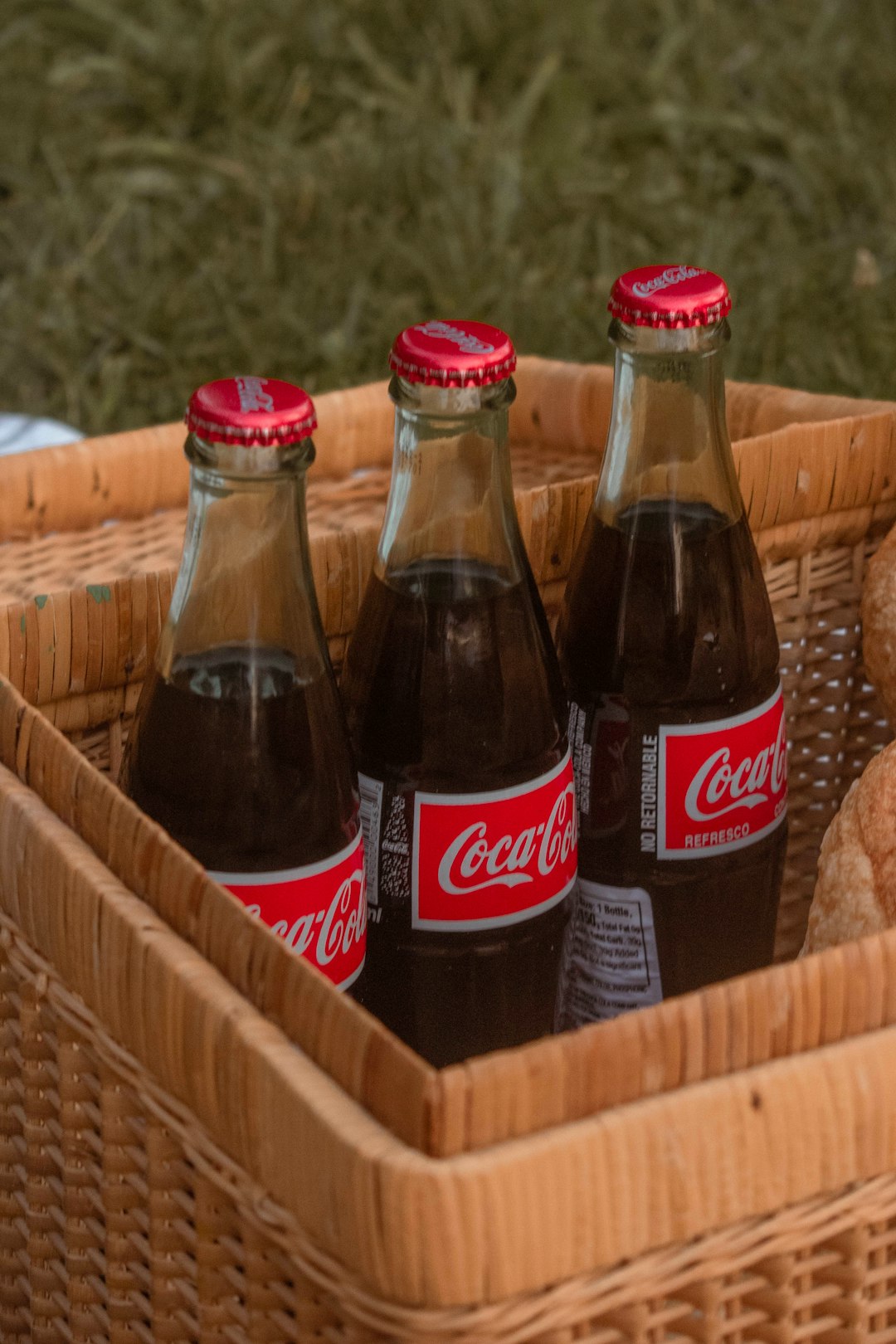 coca cola bottles on brown woven basket