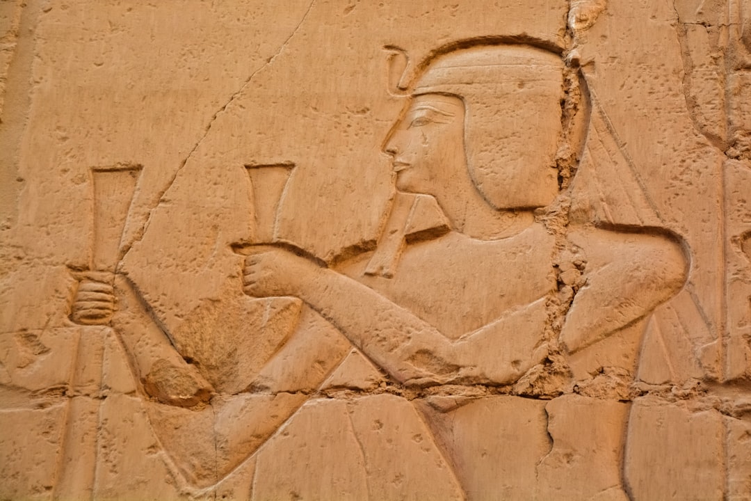 brown concrete wall with human face carved