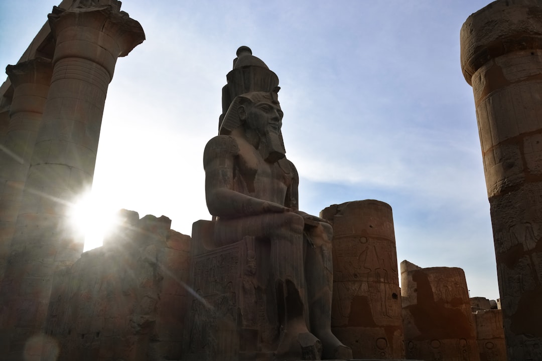 brown concrete statue under white sky during daytime