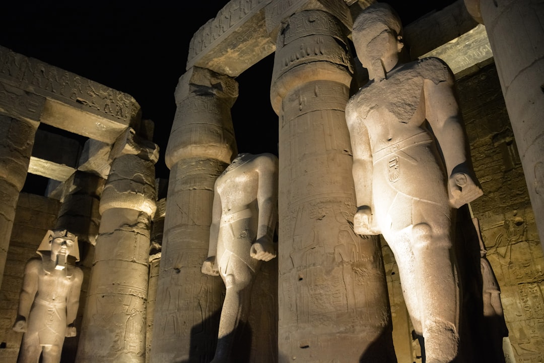 gray concrete statues during night time