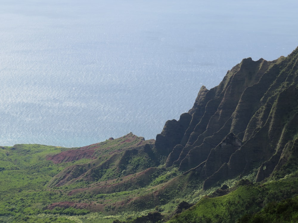 green and brown mountain under white sky during daytime