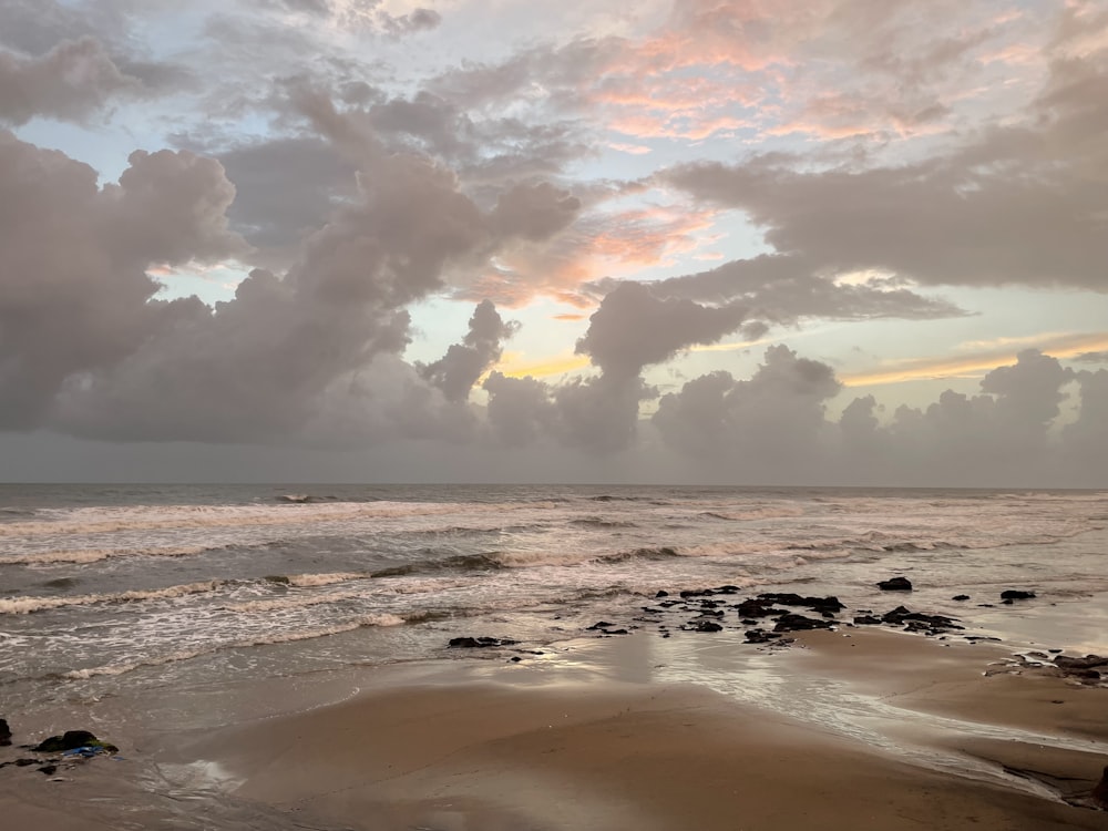 ocean waves crashing on shore during sunset