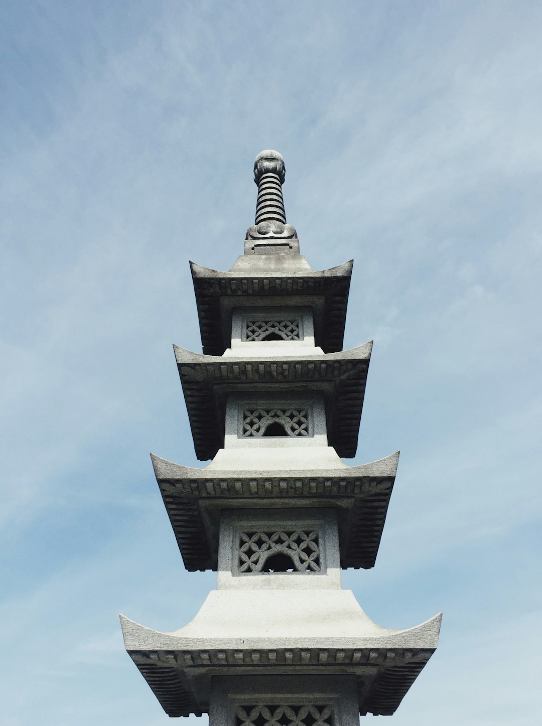 white and black concrete tower under blue sky during daytime