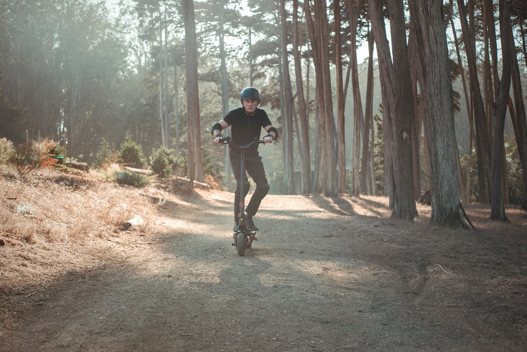 man in black t-shirt and black pants running on forest during daytime