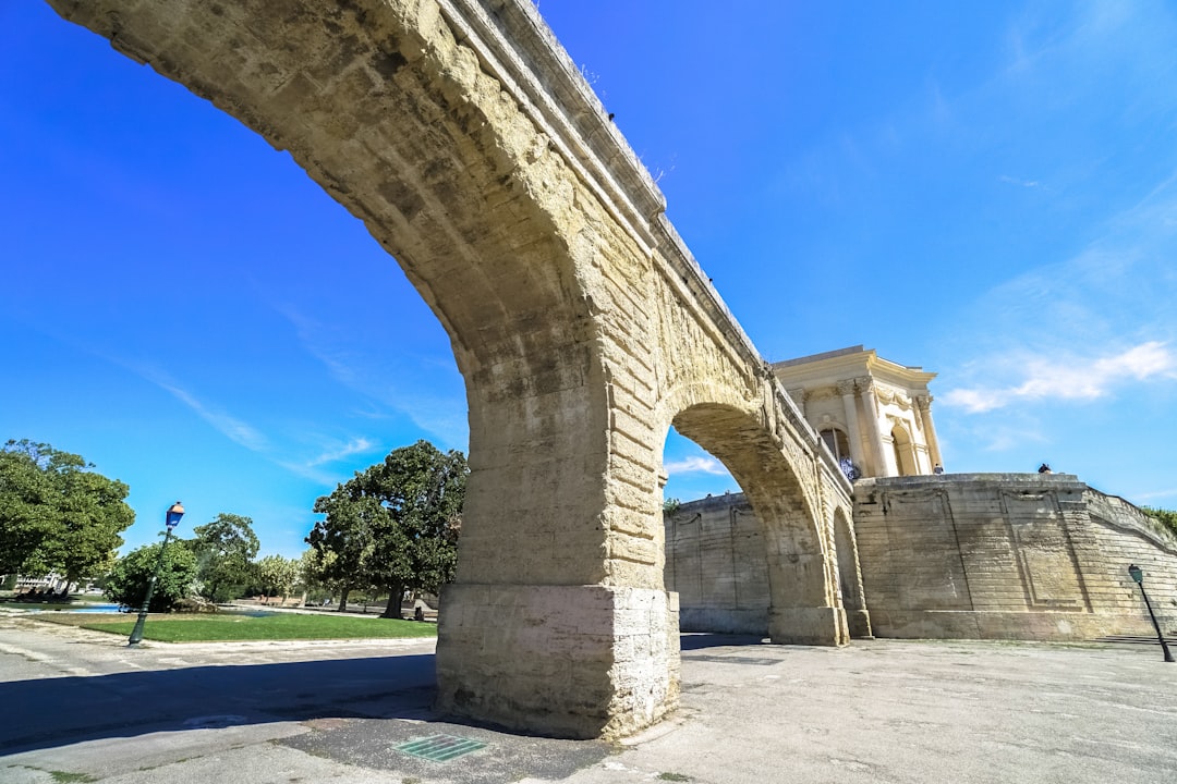 brown concrete bridge under blue sky during daytime