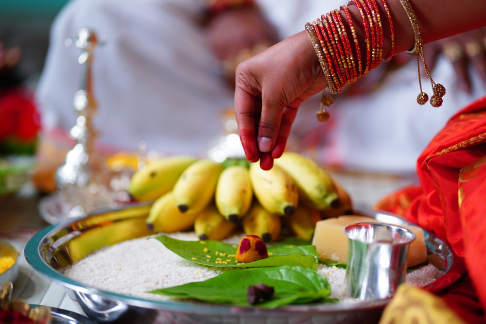 person holding sliced green fruit