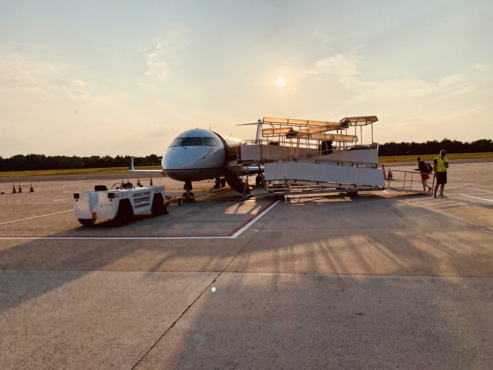 white airplane on gray concrete road during daytime