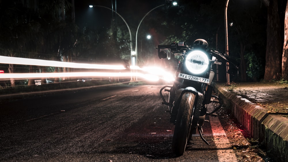 black motorcycle on road during night time