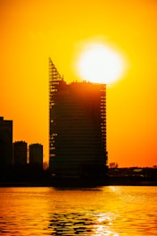 A sleek 3D rendering showcasing the towering 45-story Trilive building at sunset.