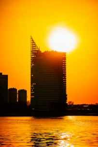 A sleek 3D rendering showcasing the towering 45-story Trilive building at sunset.