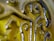 Close-up detail of a green glass surface with decorative swirls and embossed patterns, reflecting light and creating a glossy texture.
