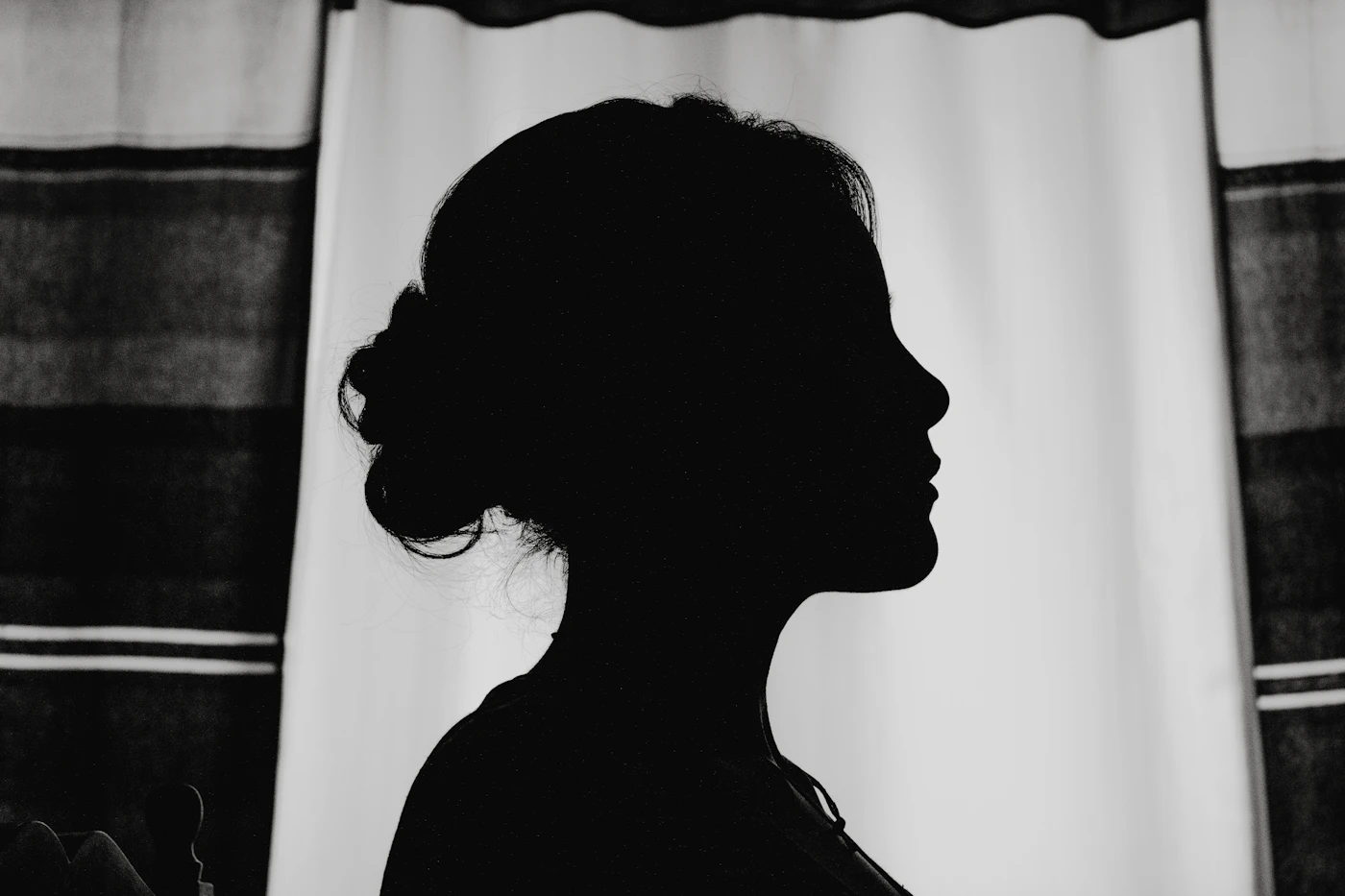 Silhouette of a woman by a window