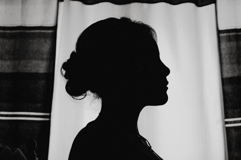 silhouette of woman standing near window