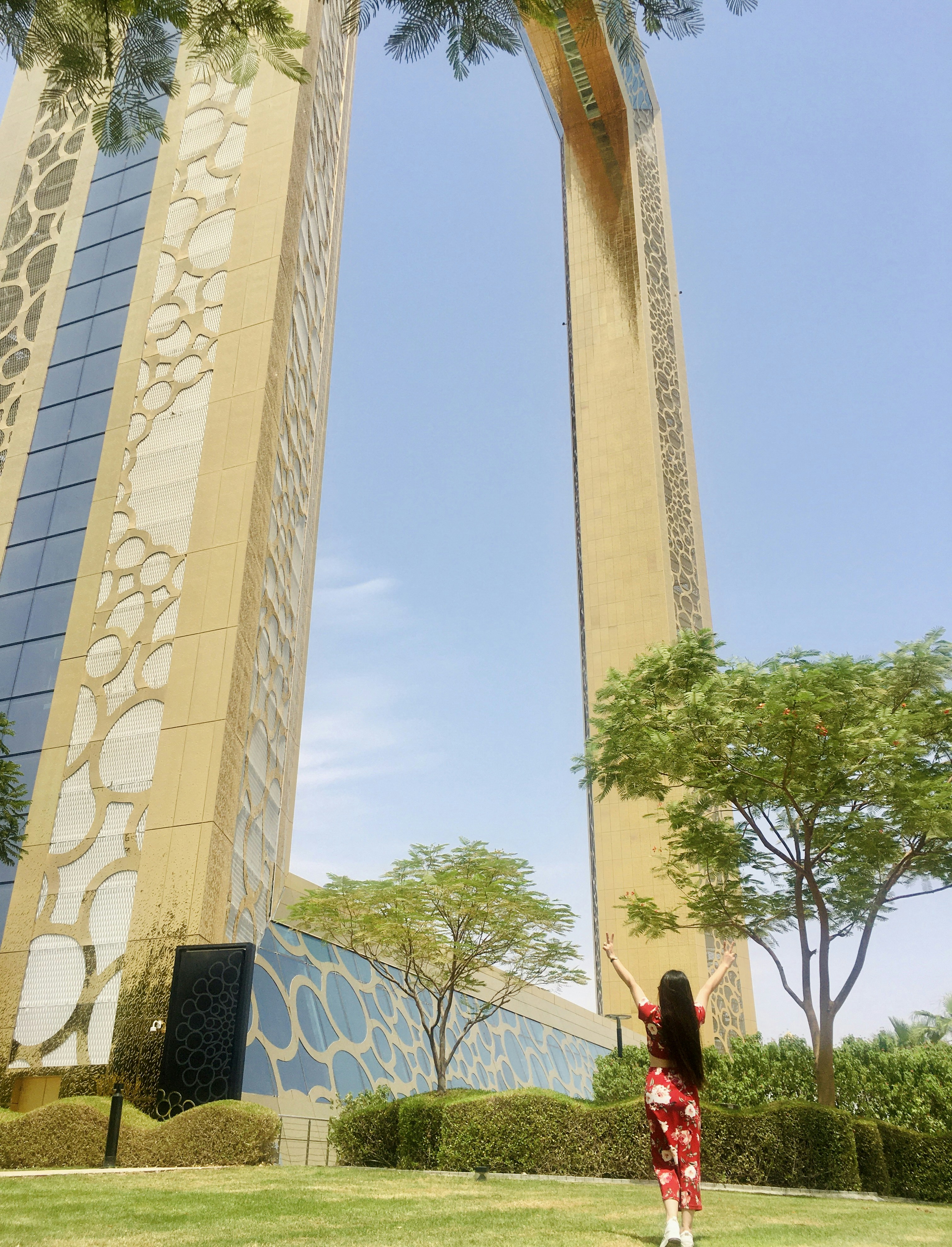 Happy woman with glowing healthy hair smiling in Dubai cityscape background