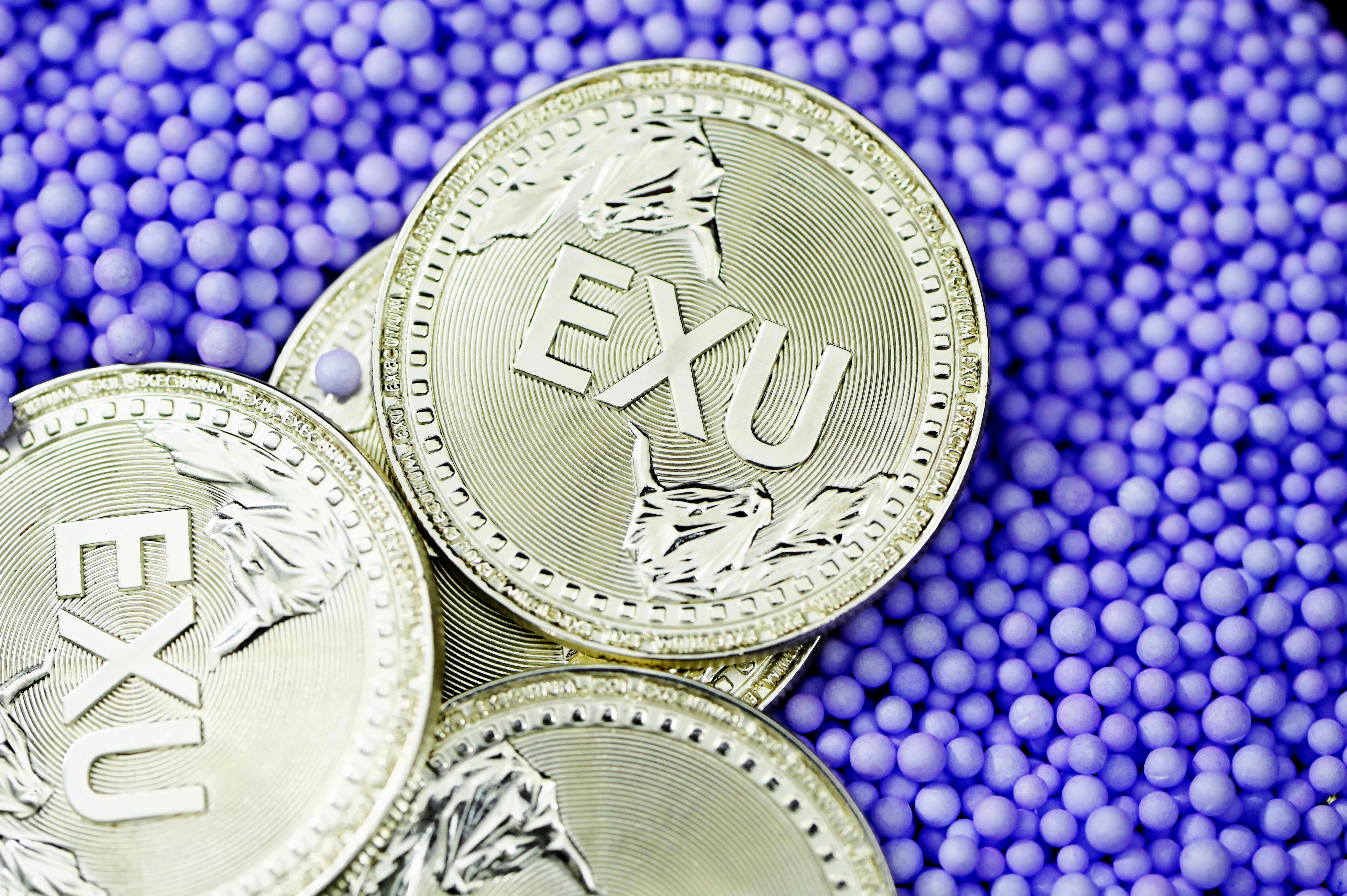 silver round coin on purple and blue beads