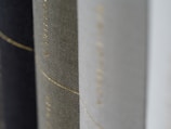 Close-up of textured book covers from Sara Claire’s collection, showing subtle embossed details.