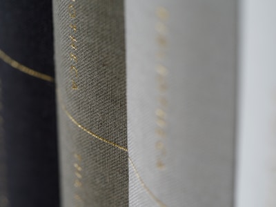 Close-up of textured book covers from Sara Claire’s collection, showing subtle embossed details.