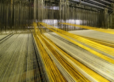 Delicate golden threads weaving together to symbolize seamless operational flow.