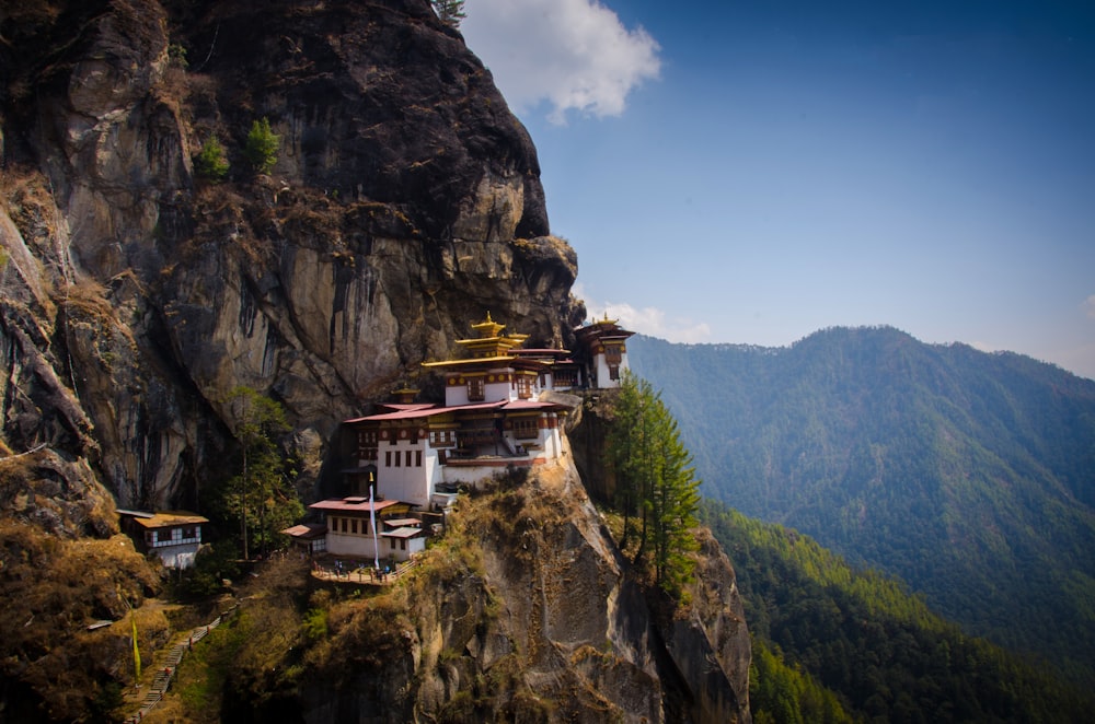 white and brown house on top of mountain during daytime