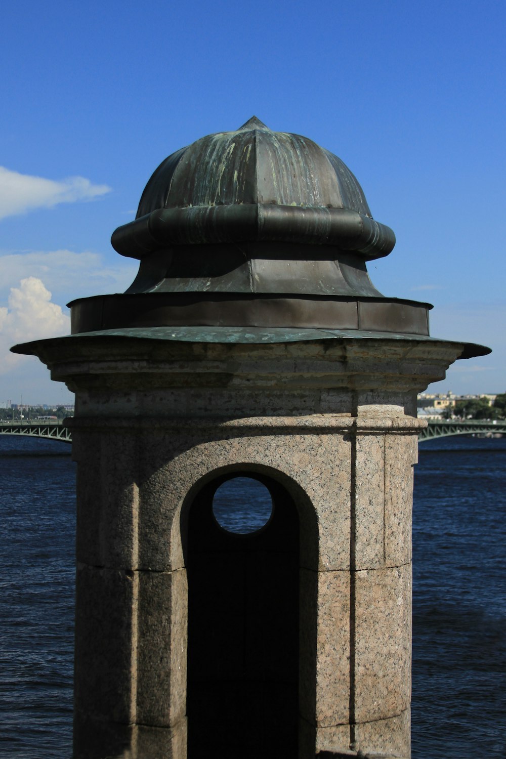 brown concrete building near body of water during daytime