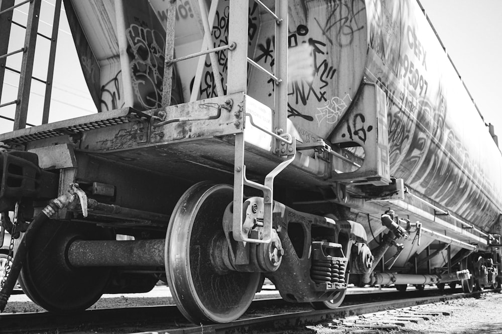 grayscale photo of train wheel