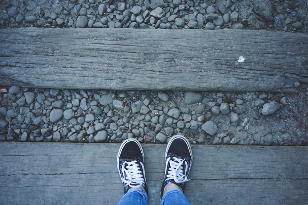 person wearing blue and white sneakers