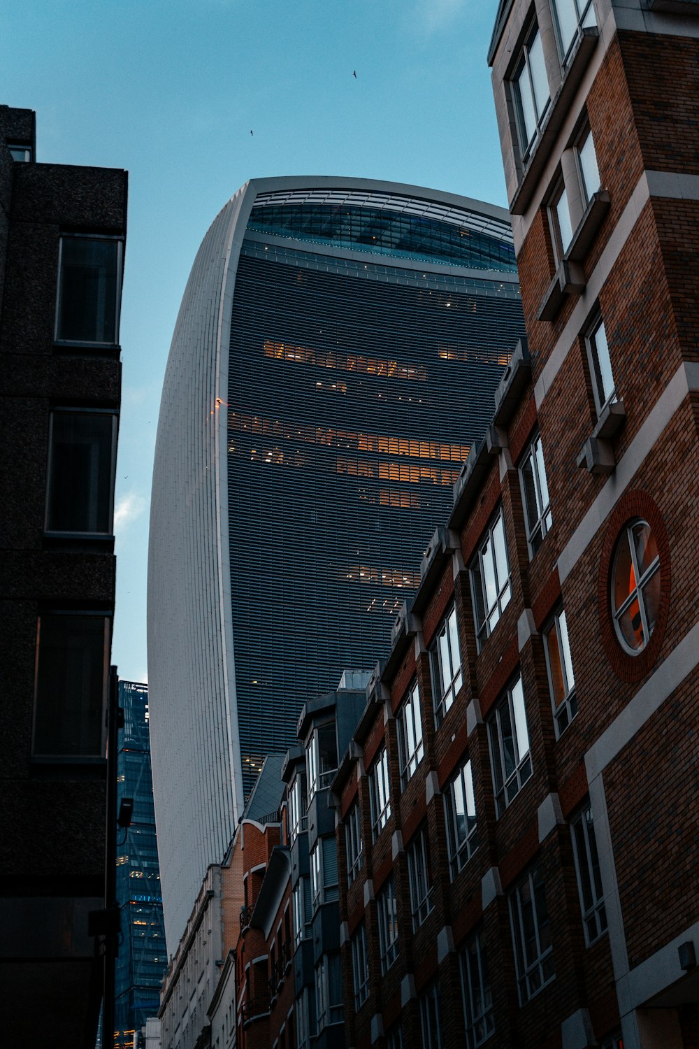 a tall building sitting next to other tall buildings