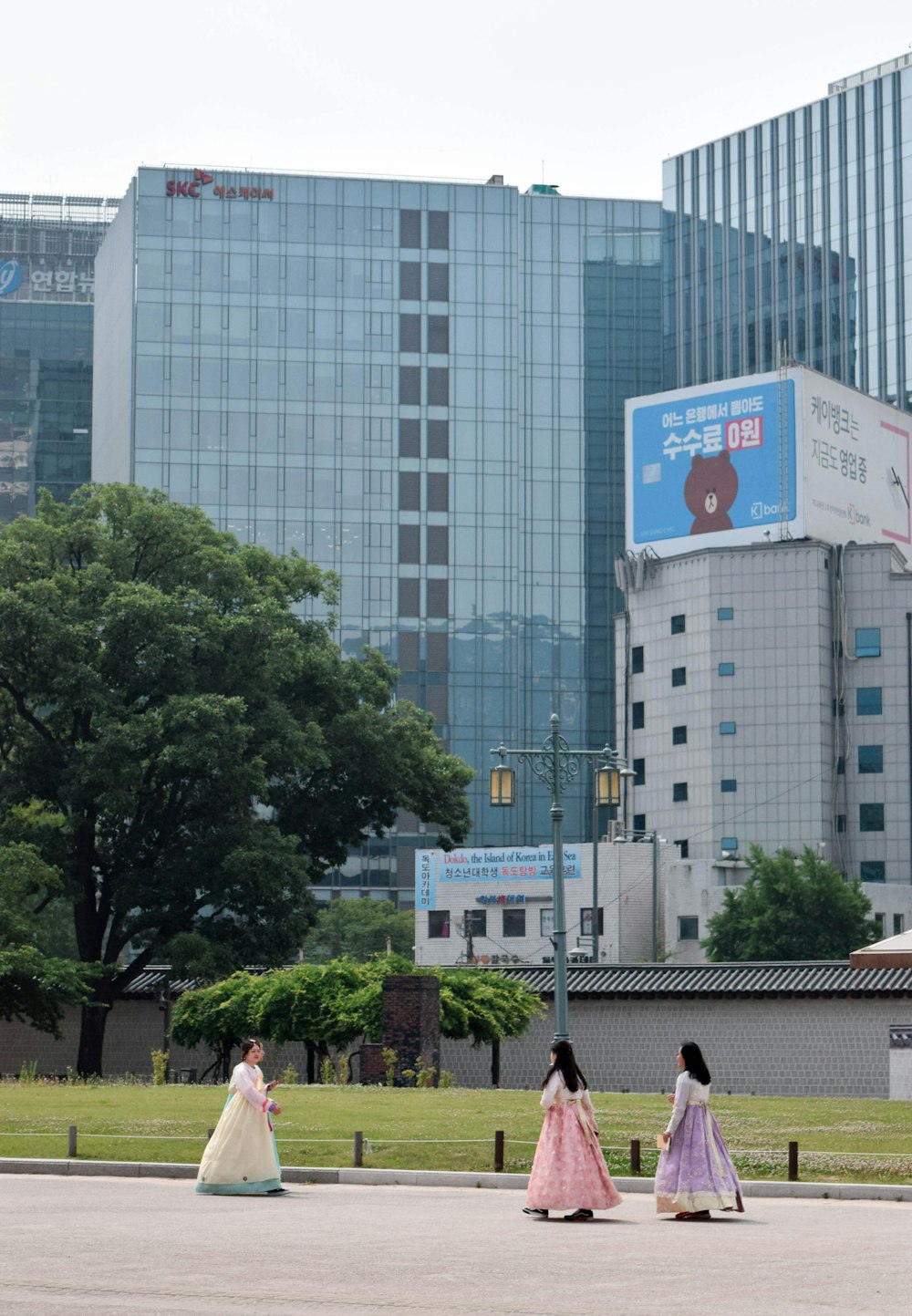 people walking on sidewalk near high rise buildings during daytime