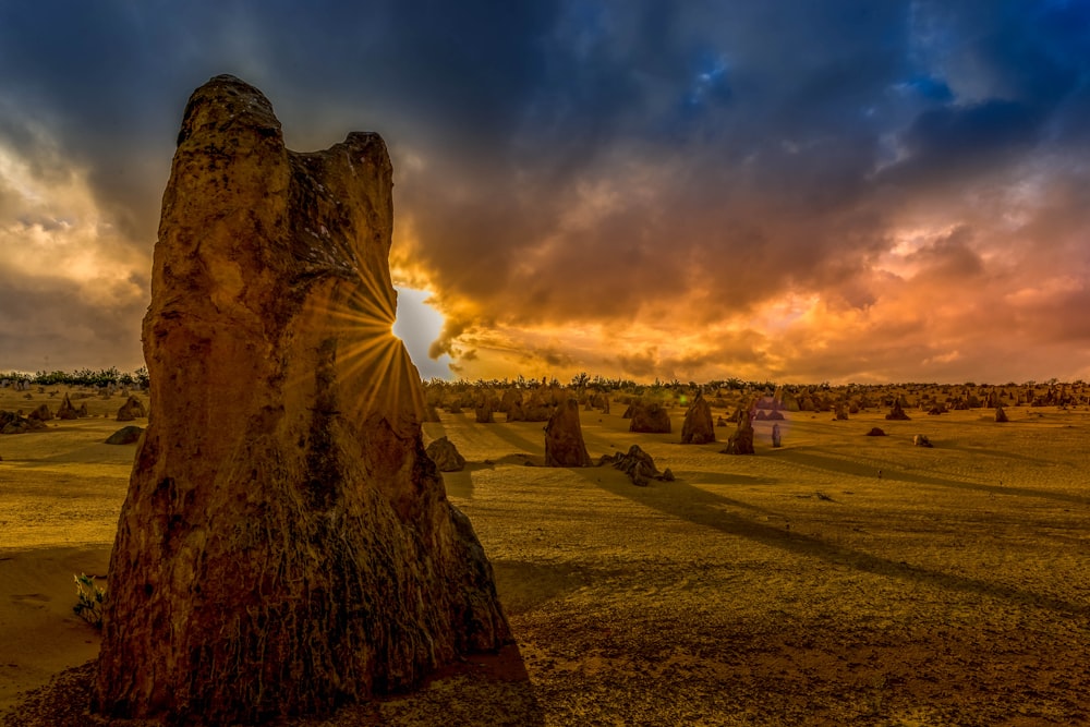 brown rock formation under cloudy sky during daytime