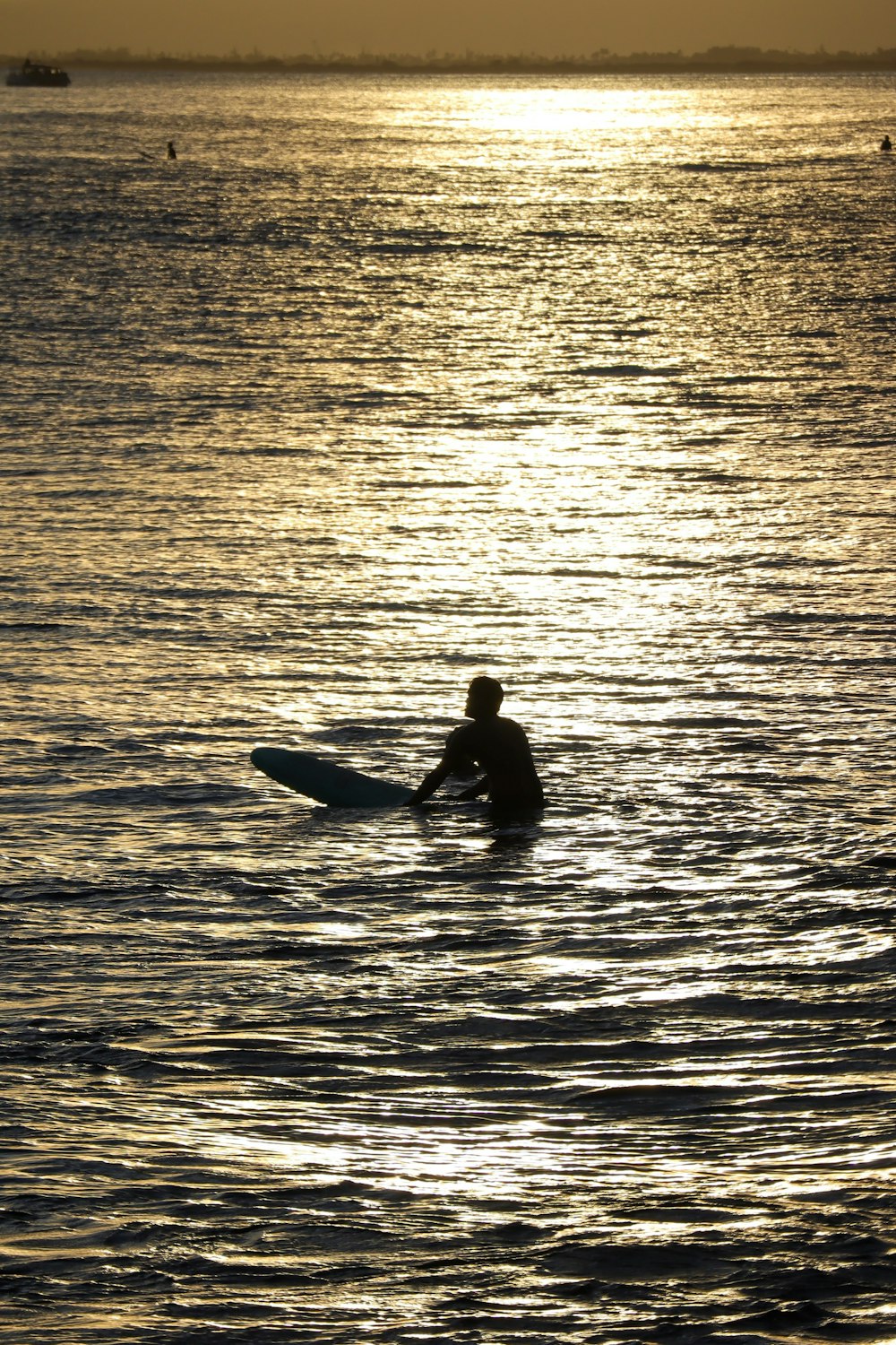 man in black wet suit riding on kayak on sea during daytime