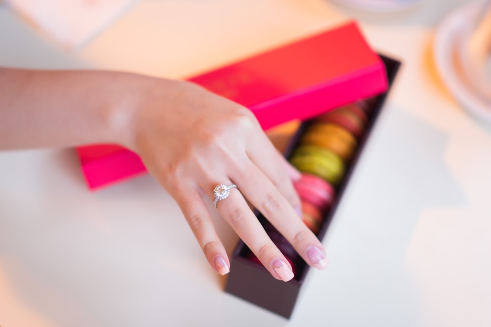 person wearing silver diamond ring