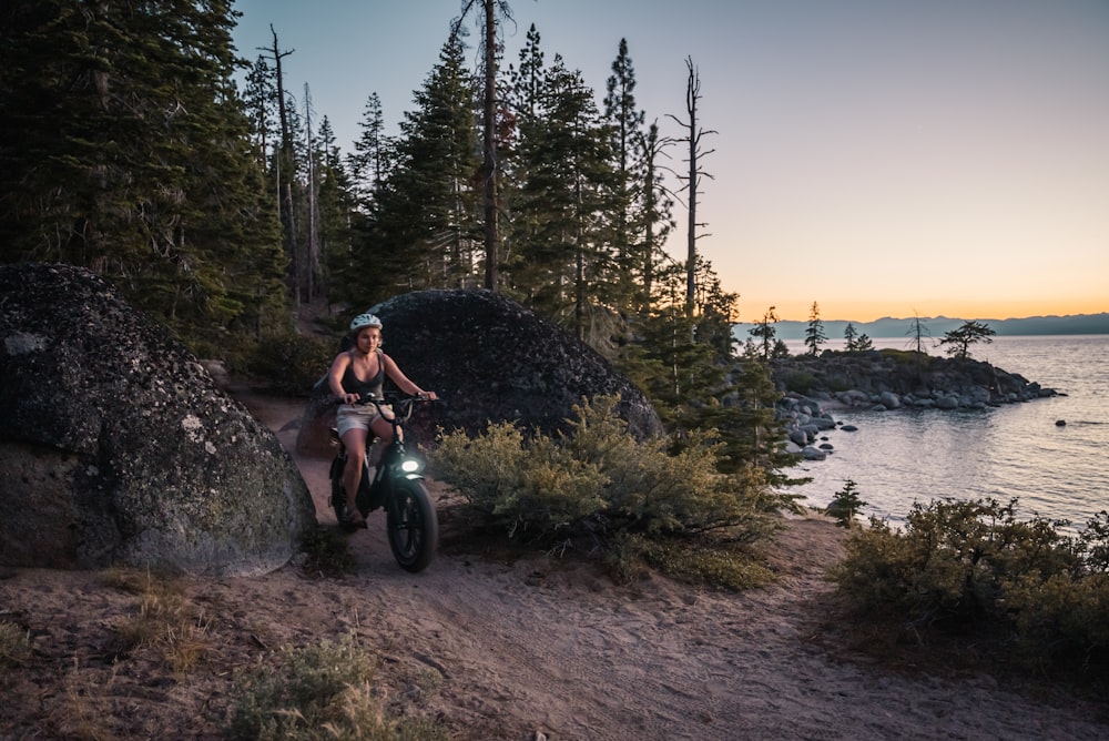 woman in black tank top riding motorcycle on road during daytime