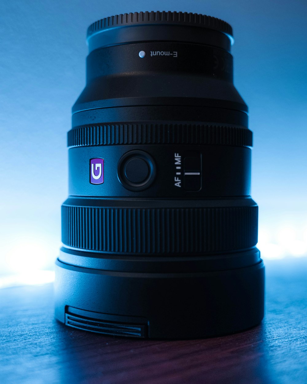 black camera lens on blue surface