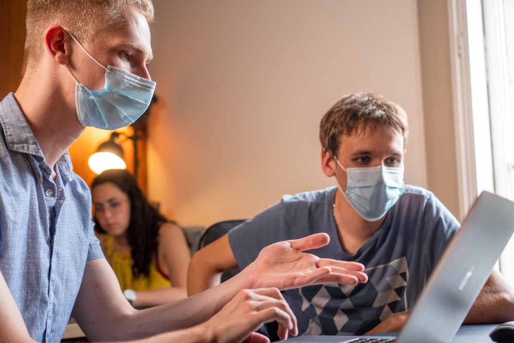 man in gray crew neck t-shirt wearing white face mask