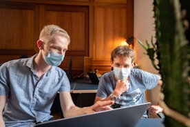 man in blue denim button up shirt wearing white goggles and blue denim vest sitting on in in in in