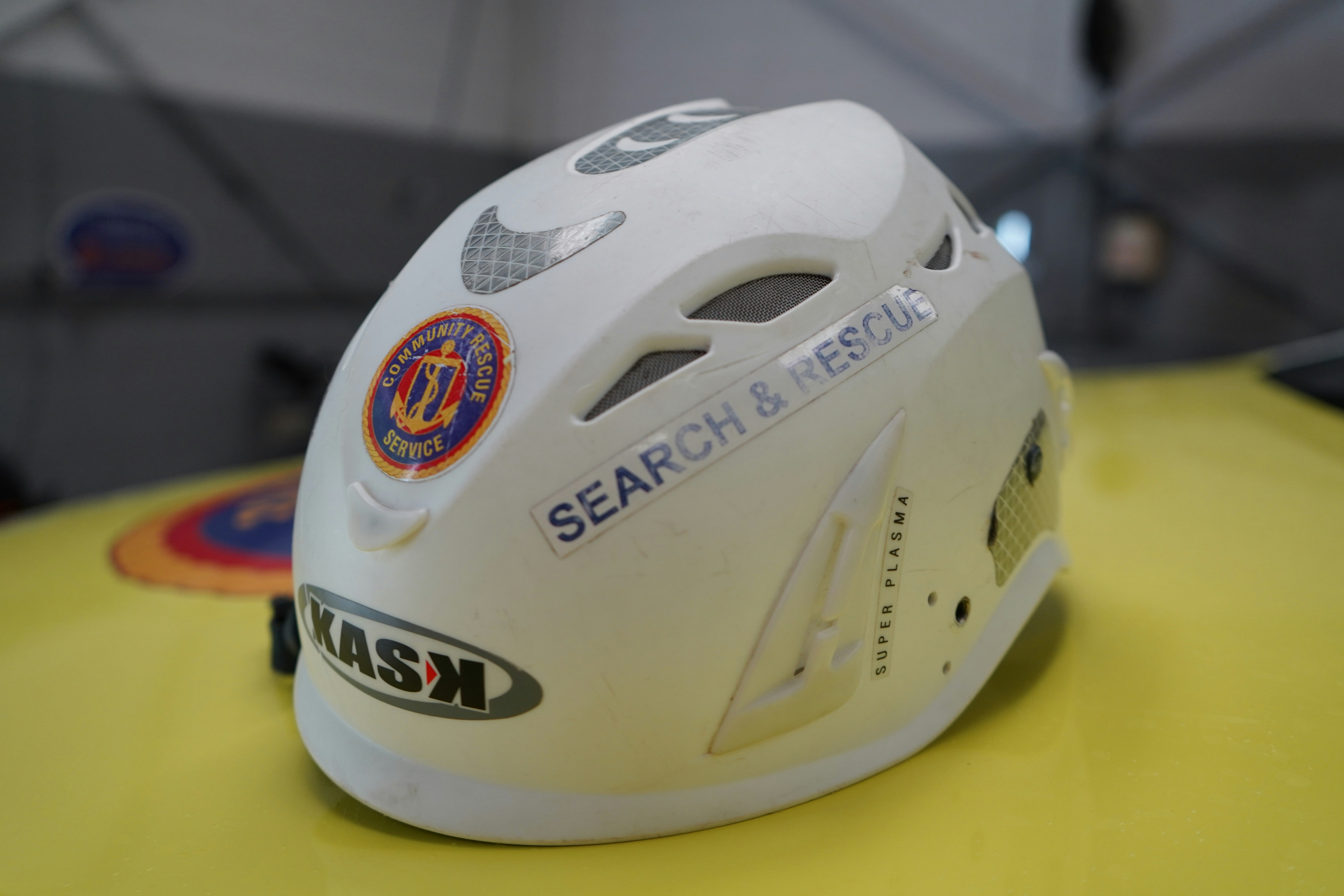a white helmet sitting on top of a yellow table
