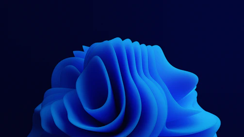 Abstract flowing blue glass shapes with soft glowing edges on a deep navy background.