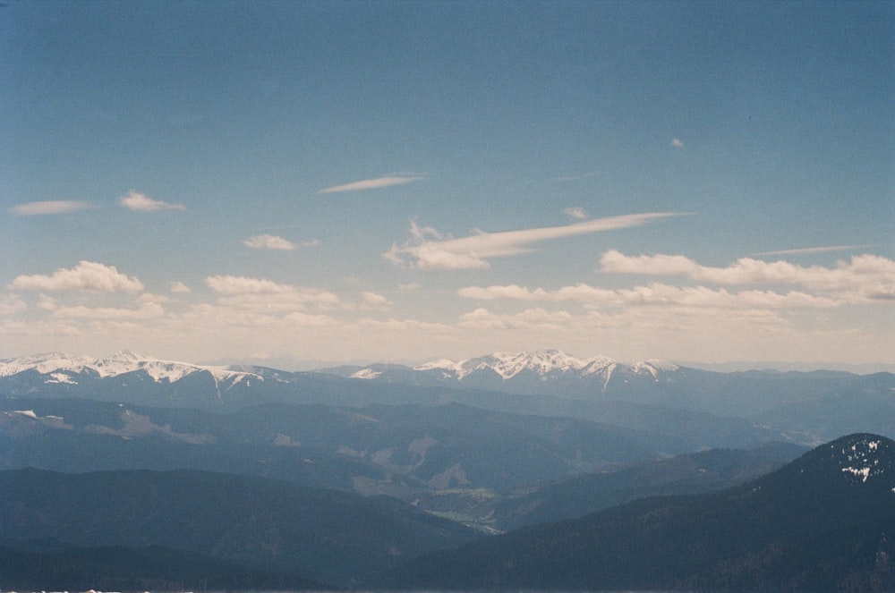 aerial view of mountains under blue sky during daytime