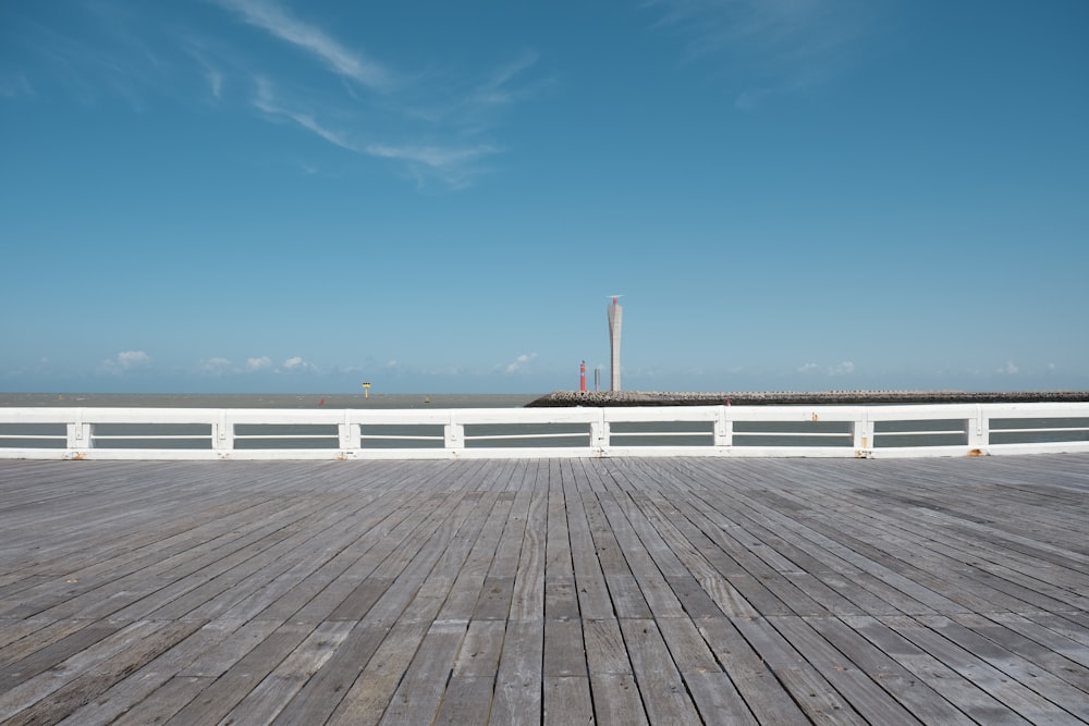 white wooden dock on blue sea under blue sky during daytime