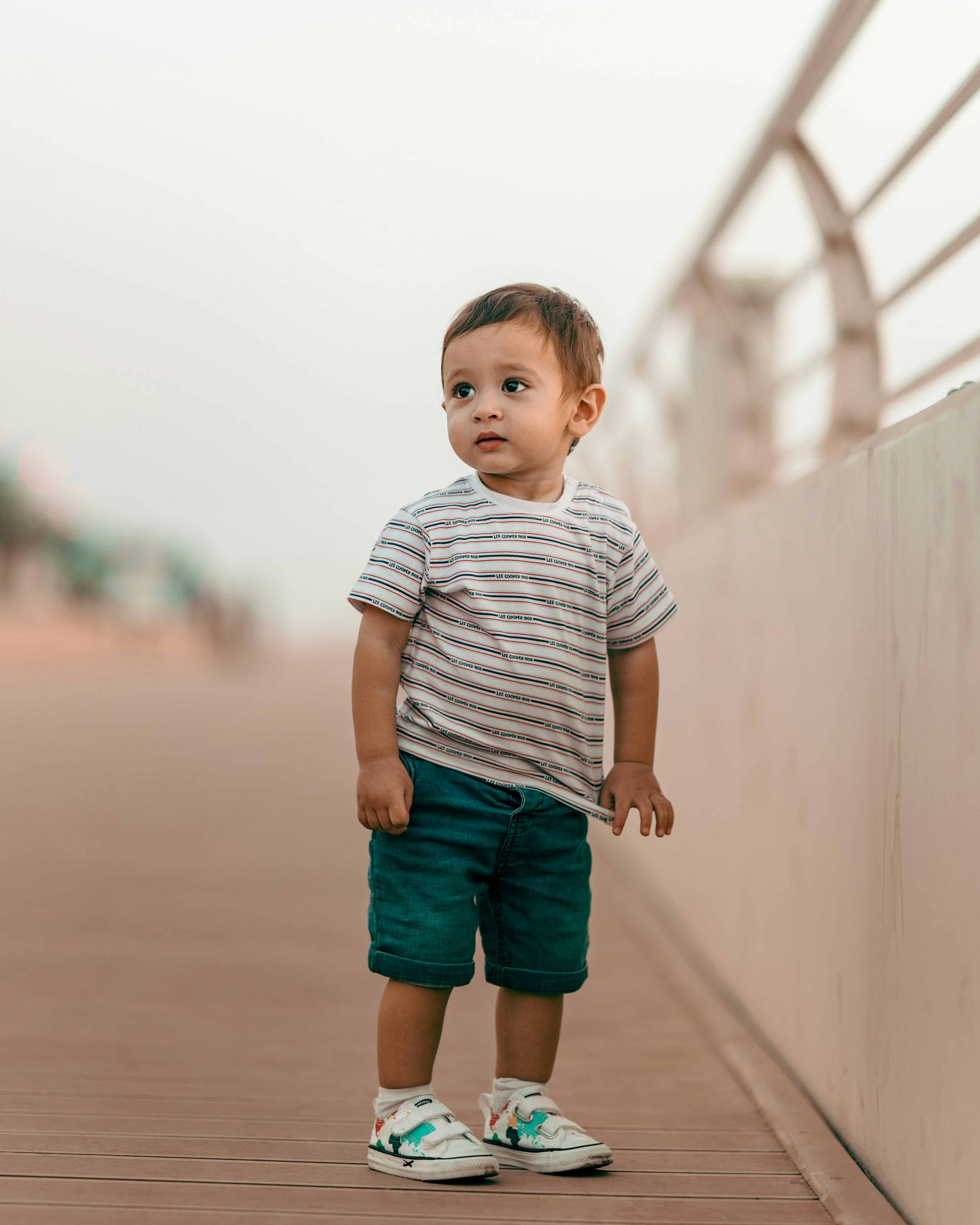 boy in white and gray stripe crew neck t-shirt and blue denim shorts standing on on on on on
