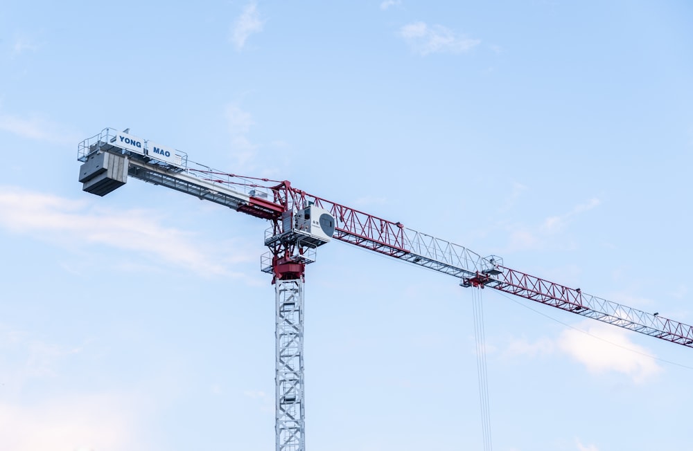 red and black crane under blue sky during daytime