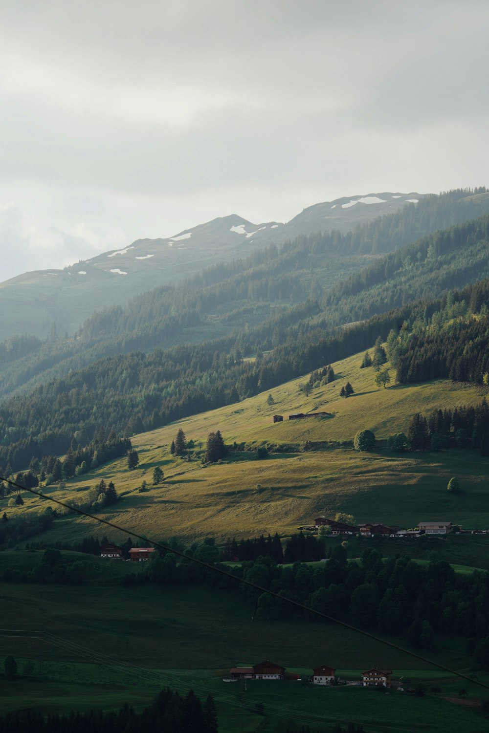 green grass field and mountains during daytime