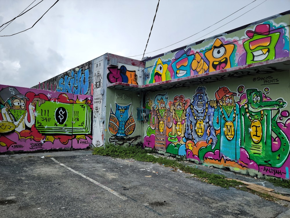 blue yellow and pink graffiti on wall