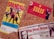 The image depicts three vintage concert tickets pinned to a corkboard. The first ticket features colorful graphics of a band called Spandau Ballet, with a predominantly yellow background. The second ticket is for a Duran Duran concert, marked by bold yellow text on a red background, with band member images in the corner. The third ticket, partially visible at the bottom, is for a Pet Shop Boys performance, showcasing an image of one of the members, along with text in red and black on a white background.