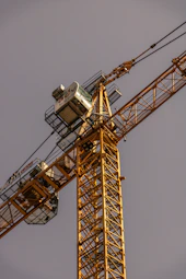 yellow and black crane under blue sky during daytime