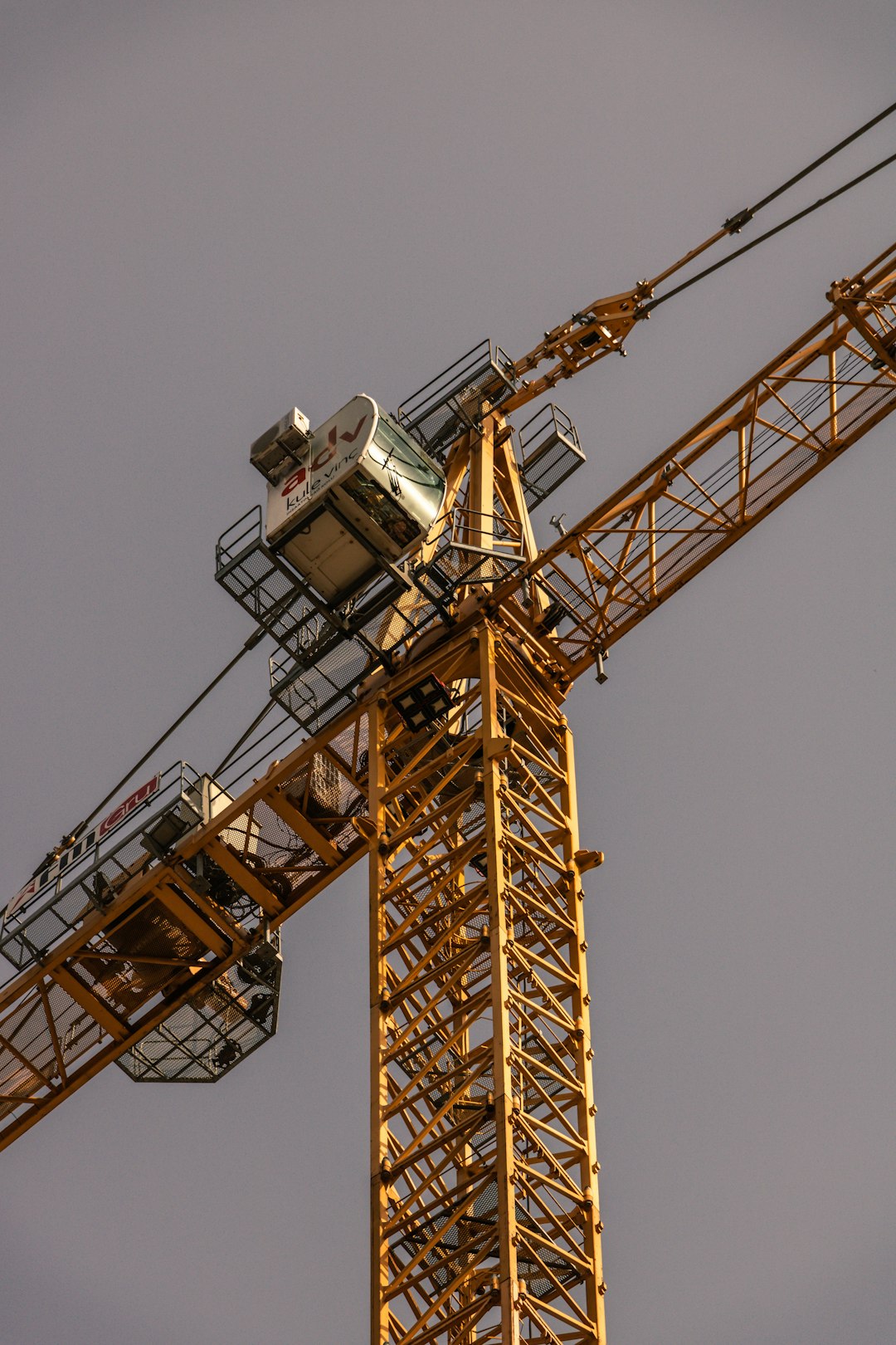 yellow and black crane under blue sky during daytime