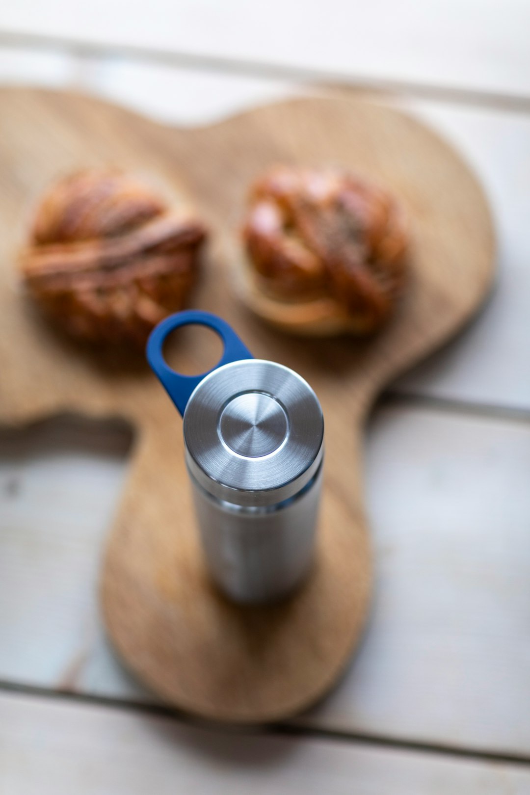 blue ceramic mug beside bread on brown wooden table