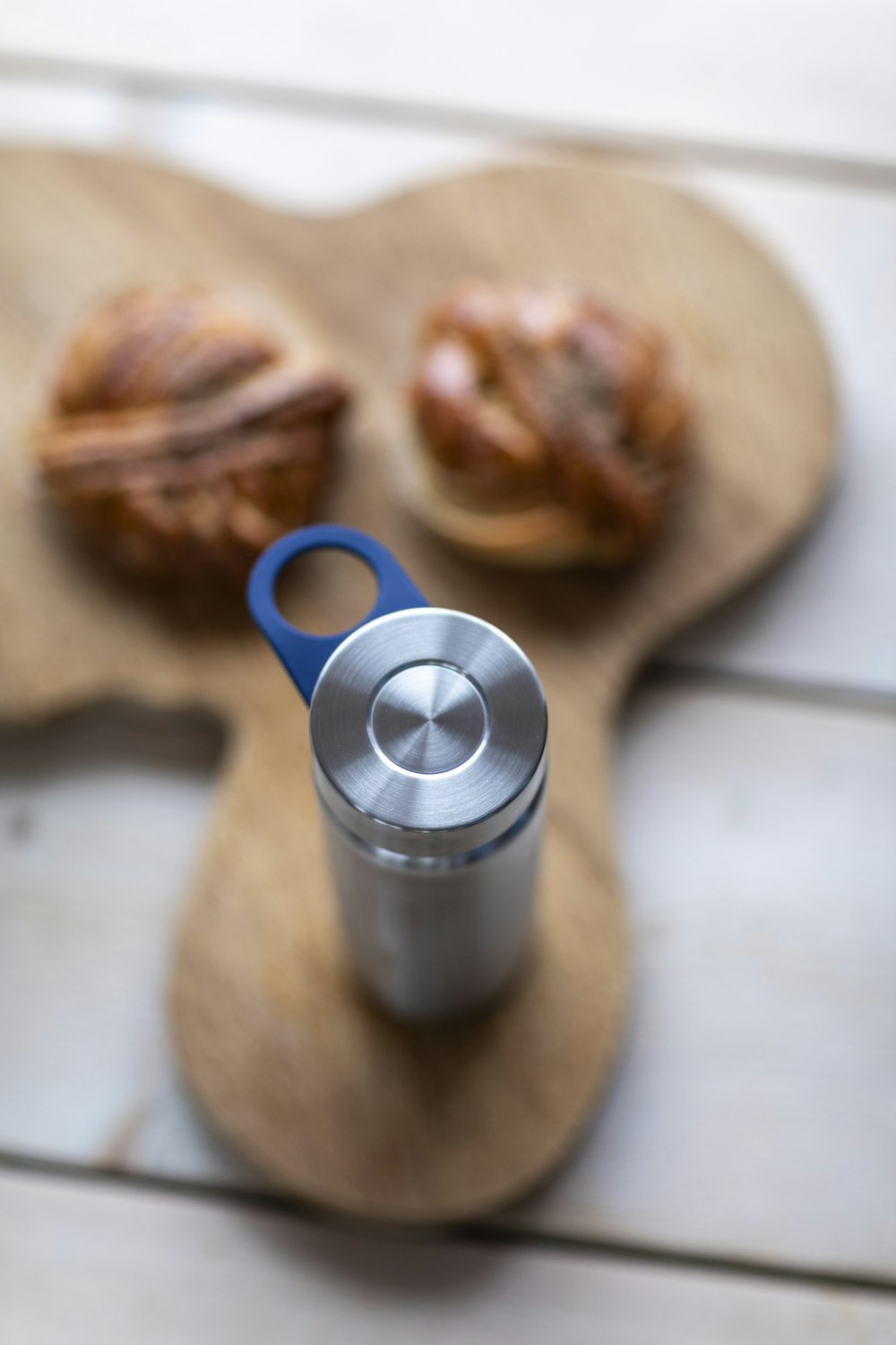 blue ceramic mug beside bread on brown wooden table