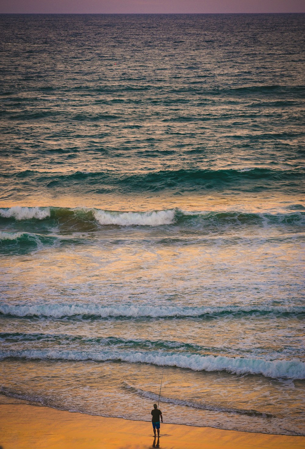 ocean waves crashing on shore during daytime