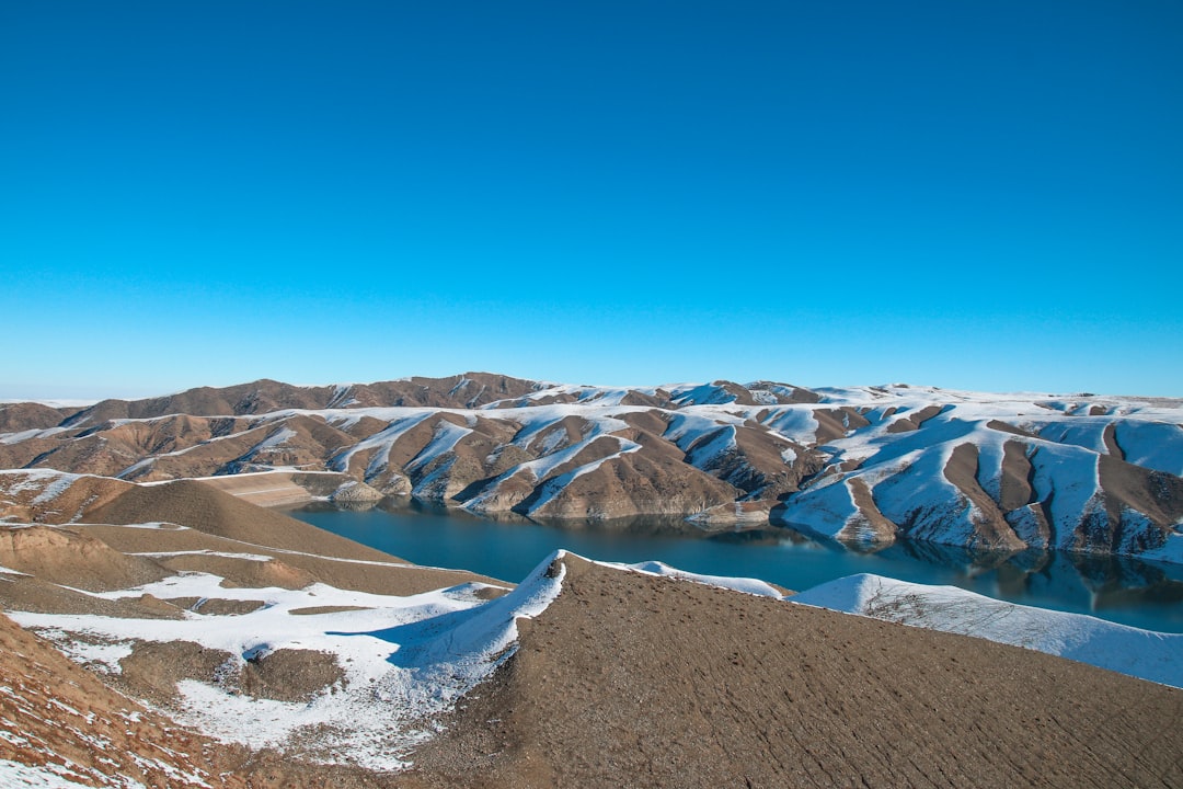 snow covered mountains under blue sky during daytime,